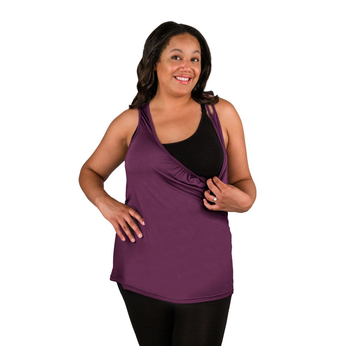 Woman wearing purple nursing tank top, pulling front down showing nursing feature