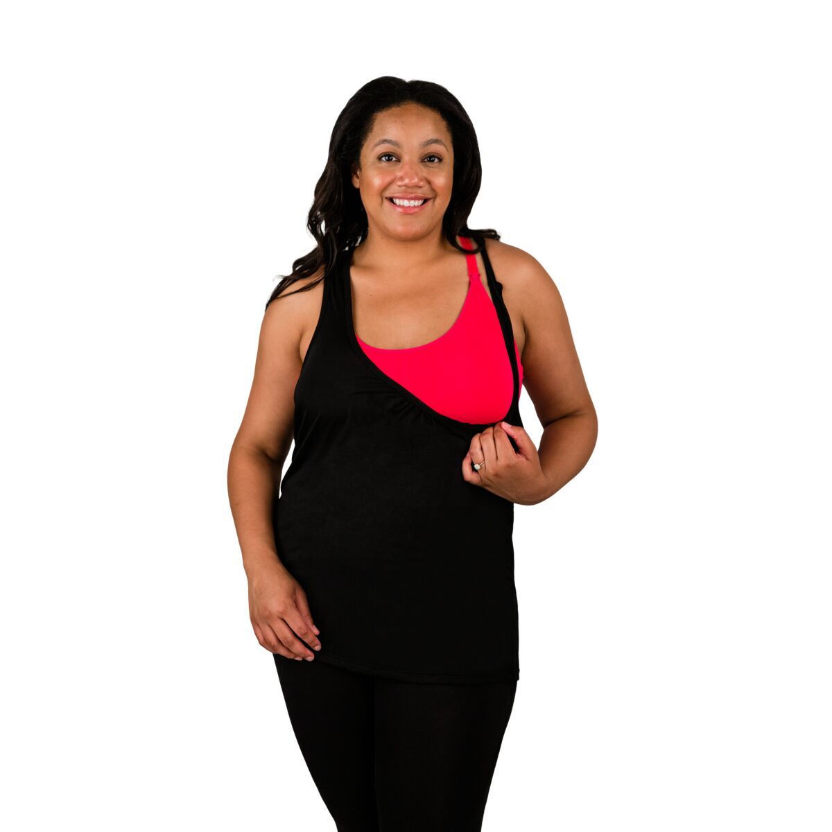 Woman wearing black nursing tank top, pulling front down showing nursing feature