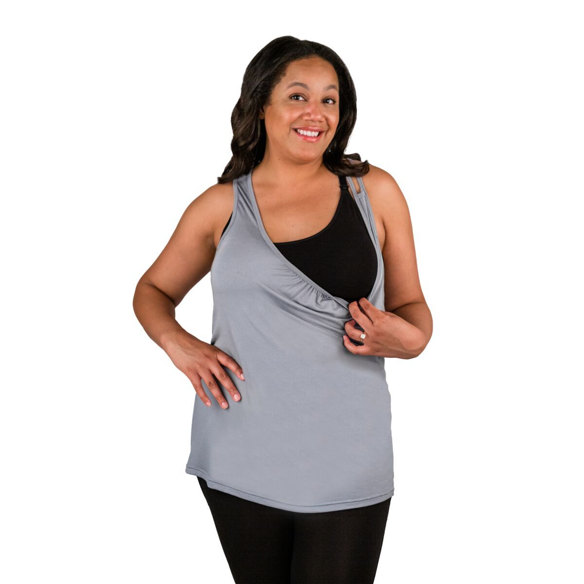 Woman wearing grey nursing tank top, pulling front down showing nursing feature