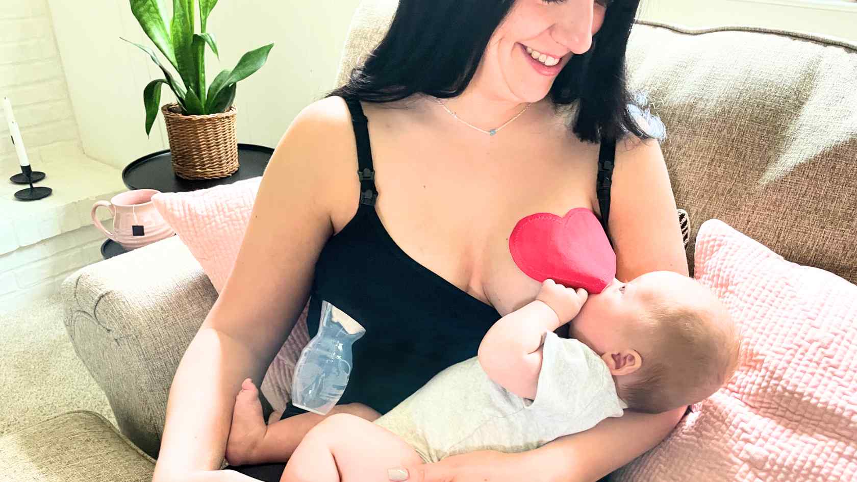 mom breastfeeding baby with a bamboobies nursing pad