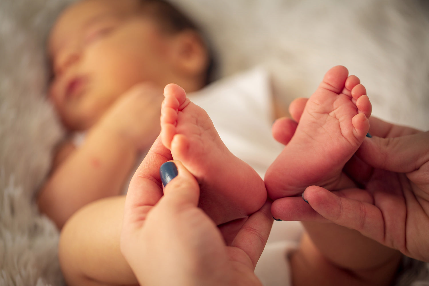 postpartum doula holding baby feet