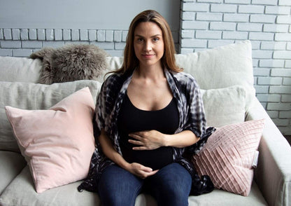 Woman wearing shibori open nursing cover sitting on couch